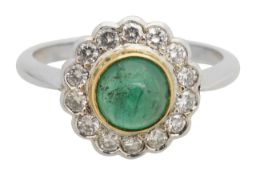 A platinum emerald and diamond daisy ring