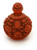 A lacquer cinnabar snuff bottle and stopper,