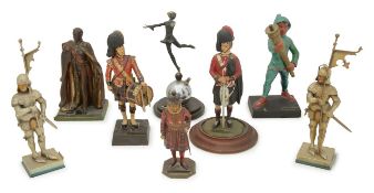 A group of eight figural table match strikers