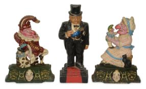 A group of three cast iron door stoppers