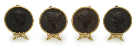 A group of four bois durci portrait roundels