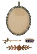 A small collection of brooches and a miniature frame