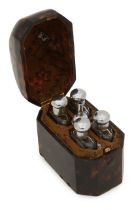 A tortoiseshell etui with silver topped scent bottles
