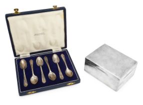 A George V silver cigarette box and cased set of teaspoons
