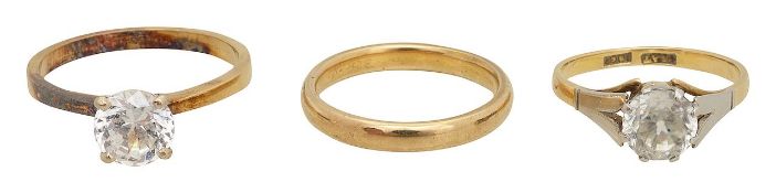 A 9ct wedding band, a white zircon solitaire and one other