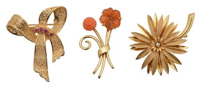 A collection of three brooches