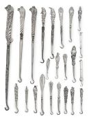 A collection of twenty three silver boot and button hooks