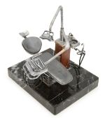 A miniature Italian silver dentist's chair