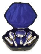 A George V silver-backed five-piece brush and mirror set,
