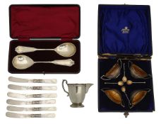 A cased set of Victorian silver salts, German serving spoons and a cream jug,