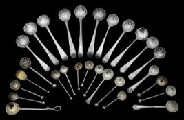 A collection of shell bowl salt spoons