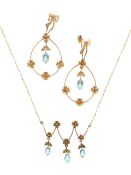 An aquamarine pair of drop earrings and necklace set