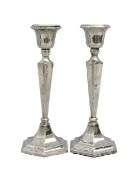 A pair of George V silver candlesticks