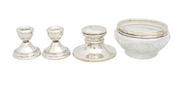 A silver inkwell, a pair of silver dwarf candlesticks, and a cut glass bowl