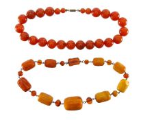 A carved amber bead necklace and another
