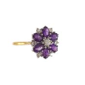 An 18ct gold diamond and amethyst flower ring