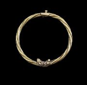 A Greek gold rams head hinged bangle