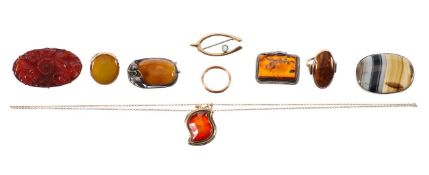 A small collection of amber brooches and rings