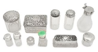 A collection of glass and silver mounted dressing table jars
