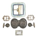 A collection of silver belt and shoe buckles
