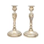 A pair of silver candlesticks, marked Sterling