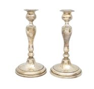 A pair of silver candlesticks, marked Sterling