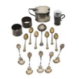 A silver mustard pot, napkin rings, and spoons