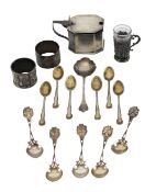 A silver mustard pot, napkin rings, and spoons