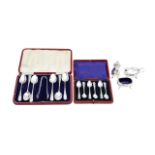 Two cased sets of silver spoons, and a silver cruet set