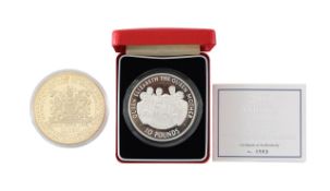 An Elizabeth II 2000 Alderney silver proof ten pounds and a 2016 gold-plated God Save the Queen coin