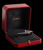 An 18K white gold and diamond Cartier 'Juste un Clou' hinged bangle