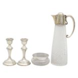 A silver mounted claret jug, dressing table jar and candlesticks