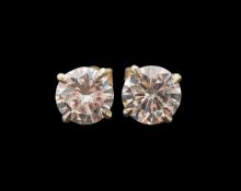A pair of solitaire diamond ear rings