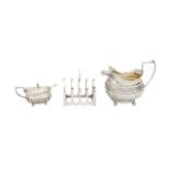 A George III silver cream jug, a toast rack, and a mustard pot