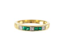 A 18ct gold, emerald and diamond set eternity band