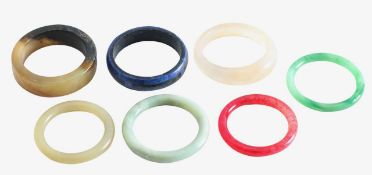 A wide engraved Chinese jade bangle and four others