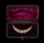 An Edwardian opal set crescent moon brooch