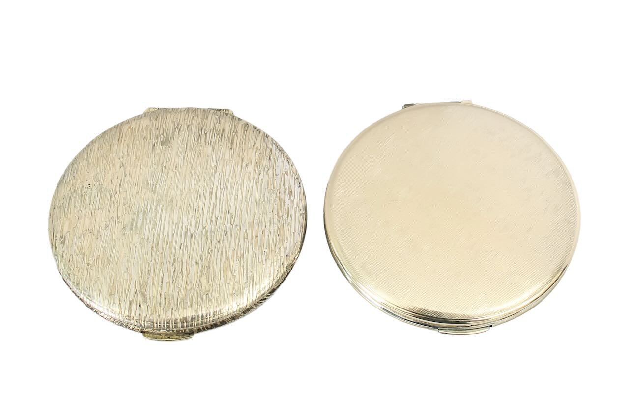 Two Kigu silver compacts