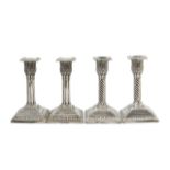 Two pairs of Victorian silver candlesticks