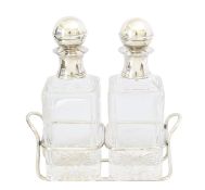 A pair of Mappin & Webb silver plated decanters on stand
