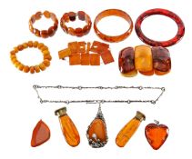 A collection of amber bracelets, pendants, seals etc.