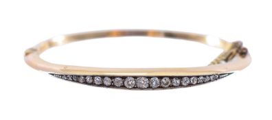 An Edwardian diamond set stiff bangle
