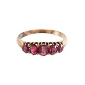 A five stone ring with four rubies and a garnet topped doublet