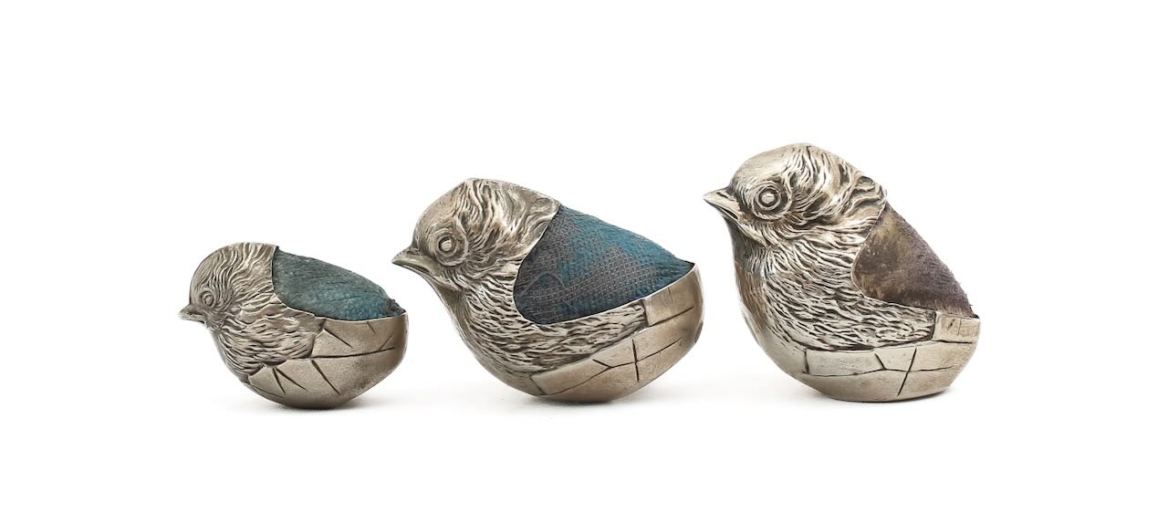 Three Sampson Mordan silver pin cushions,