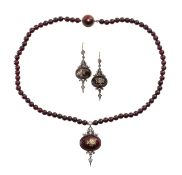 A suite of diamond and garnet bespoke made necklace and ear pendants