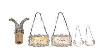 Four silver decanter labels and a silver mounted cork
