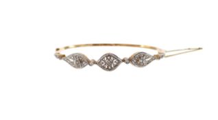 An Edwardian diamond set hinged bangle