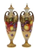 A pair of Royal Worcester porcelain painted fruit vases and covers