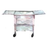 A chrome, glass and mirrored surgical trolley cabinet,