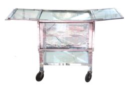 A chrome, glass and mirrored surgical trolley cabinet,